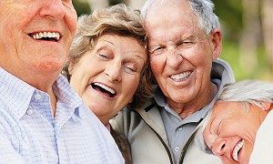 Portrait of a cute happy senior couple laughing together while in bed